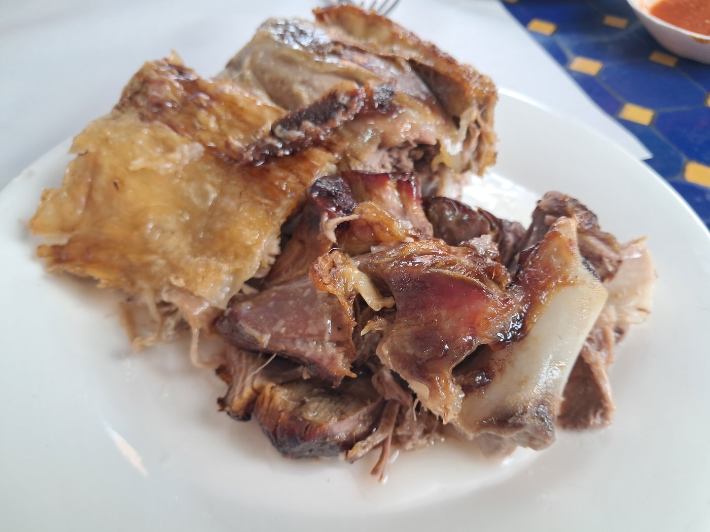 Mechoui lamb at Chez Lahmine, Marrakech — crisp-skinned, cooked in its own juices