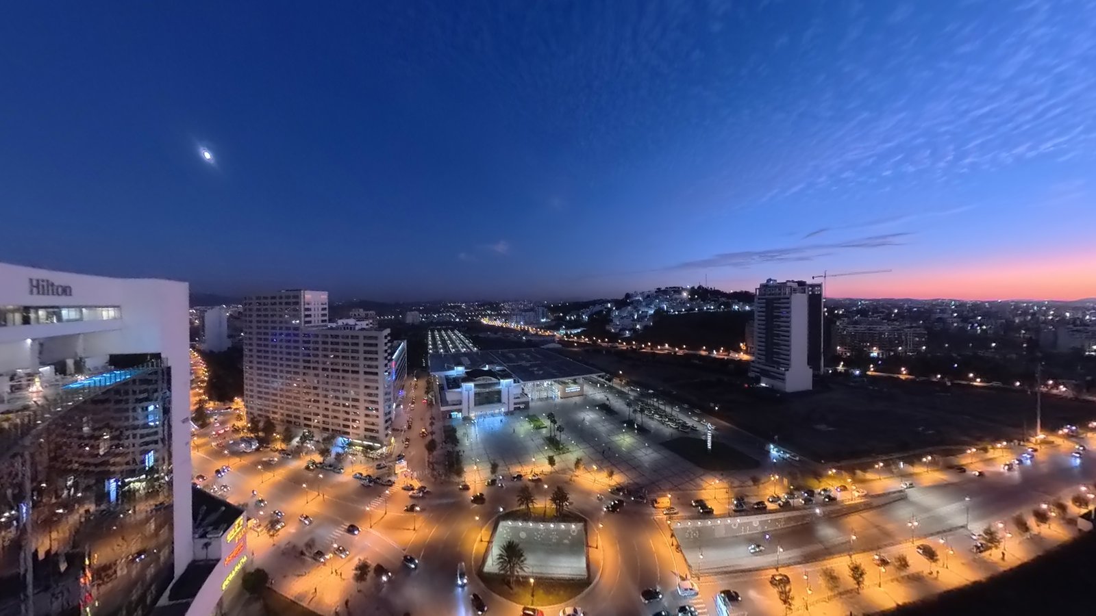 Tangier at dusk from the Hilton rooftop — the bay, the sunset and the city lights
